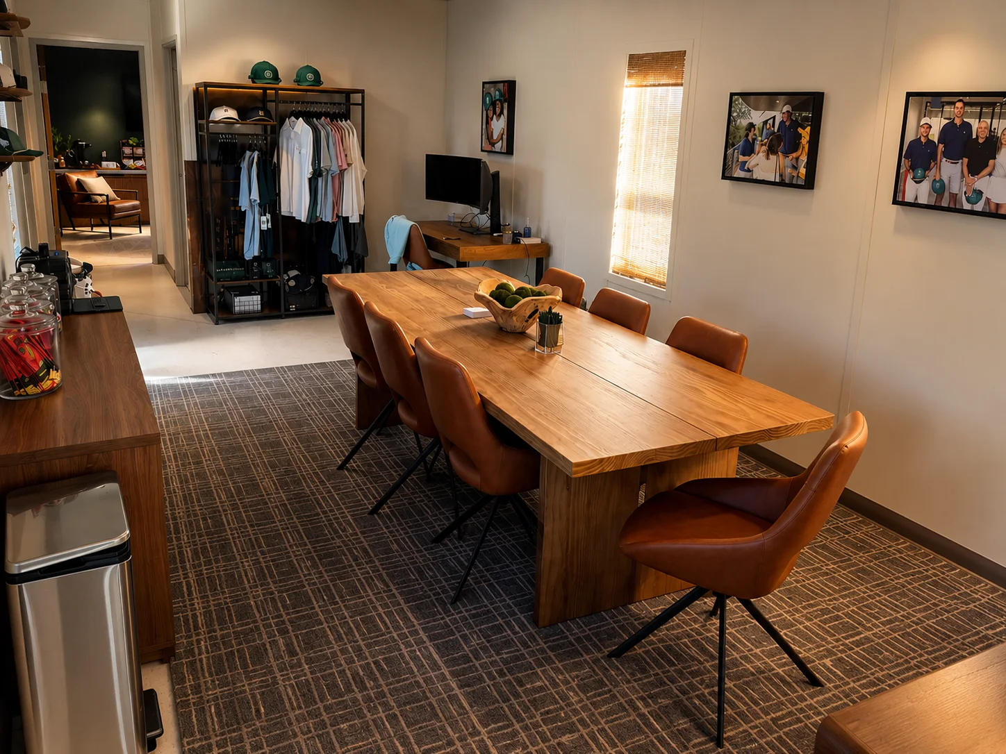 Meeting table, club apparel, and workstations inside the temporary Mackenzie membership office